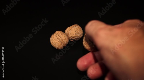 Close-up of a hand holding fresh, raw walnuts. Perfect for healthy eating, nutrition, keto diet, organic snacks, and natural food market projects.