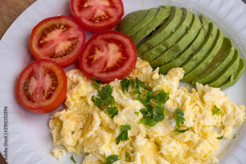 Scrambled eggs with avocado and tomato