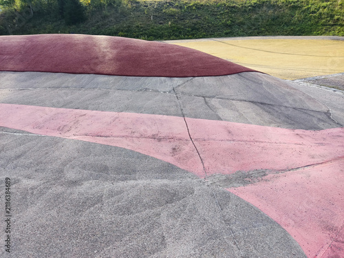 Modern pink concrete ramp on a green grass hill