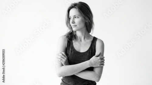 Pensive Young Woman Looking Away Arms Crossed Studio Portrait Black And White