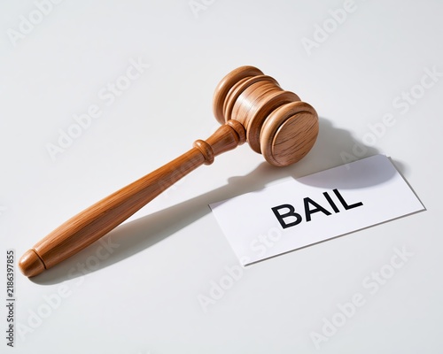 Wooden Judge Gavel Lying Next to Bail Text on White Background