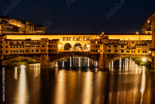 Принти на полотні Ponte Vecchio bridge illuminated at night over the Arno River in Florence, Italy