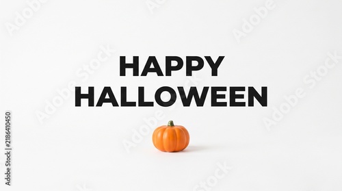 Happy Halloween text greeting with a small orange pumpkin isolated on a white background
