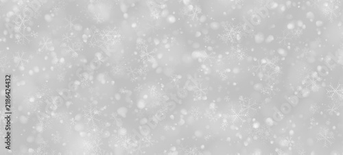Bild auf Leinwand Delicate snowflakes scatter across a dark and softly blurred background
