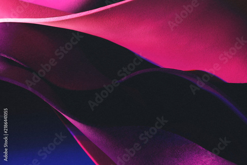 Grunge abstract background with wavy shapes in darkness. Studio shot photo