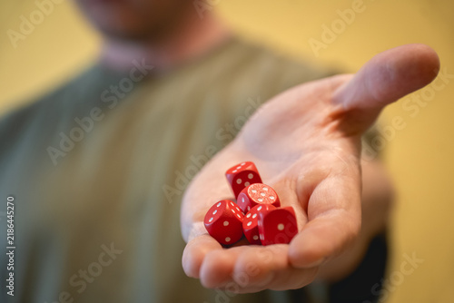 Obraz na płótnie Open hand offering a pile of red dice