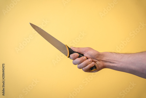 Obraz na płótnie Hand holding a kitchen knife arm extended
