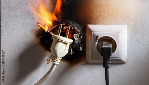 Naklejka fire hazard from melted power plug and charred wall socket