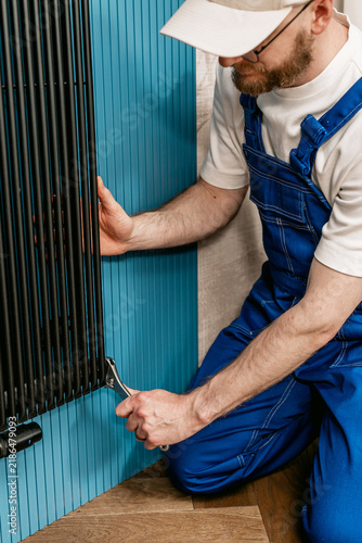 Repairman use wrench tool to fix prepare the home heating system