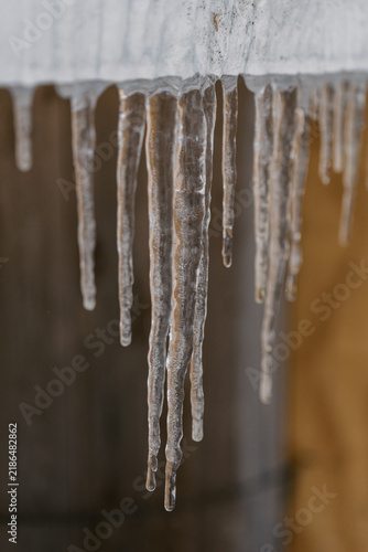 Icicles hanging down with dark background