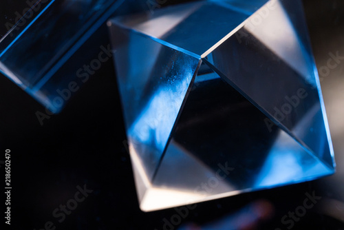 Blue light refracted through geometric glass prism