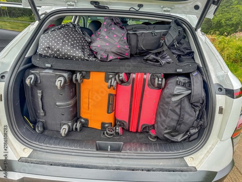 Принти на полотні Fully loaded car trunk containing several suitcases, bags, and backpacks—luggage stowed efficiently to save space