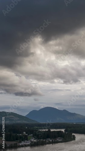 Panoramic View of the Fraser River and Mountains in Chilliwack, British Columbia Under Dramatic Clouds