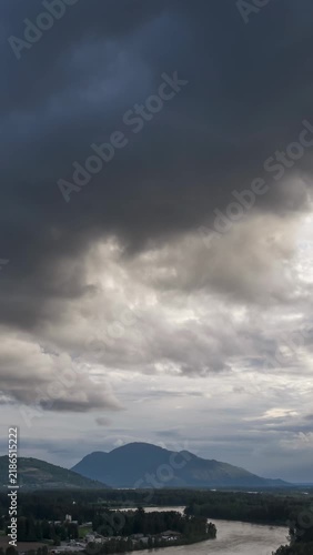 Dramatic Cloudscape Over Chilliwack's Fraser River and Majestic Mountains in British Columbia, Canada