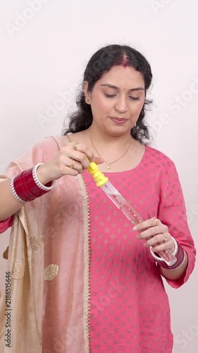 Vertical Shot of Playful Married Indian Woman Blowing Soap Bubbles – Carefree Lifestyle Concept