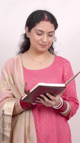 Vertical Shot of Happy Married Indian Woman Opening and Reading a Diary