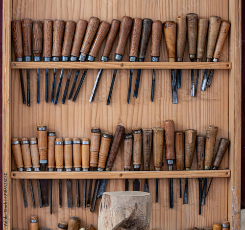 Canvastavla Wooden display rack with various traditional woodcarving chisels and gouges in a