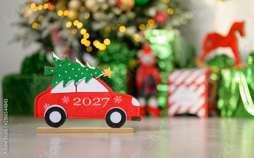Happy New Year 2027. Christmas toys by the tree on Christmas Eve.