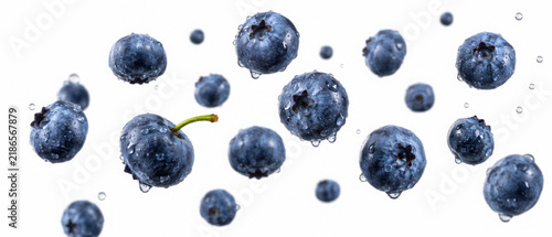 Falling blueberries with water drops isolated on transparent background