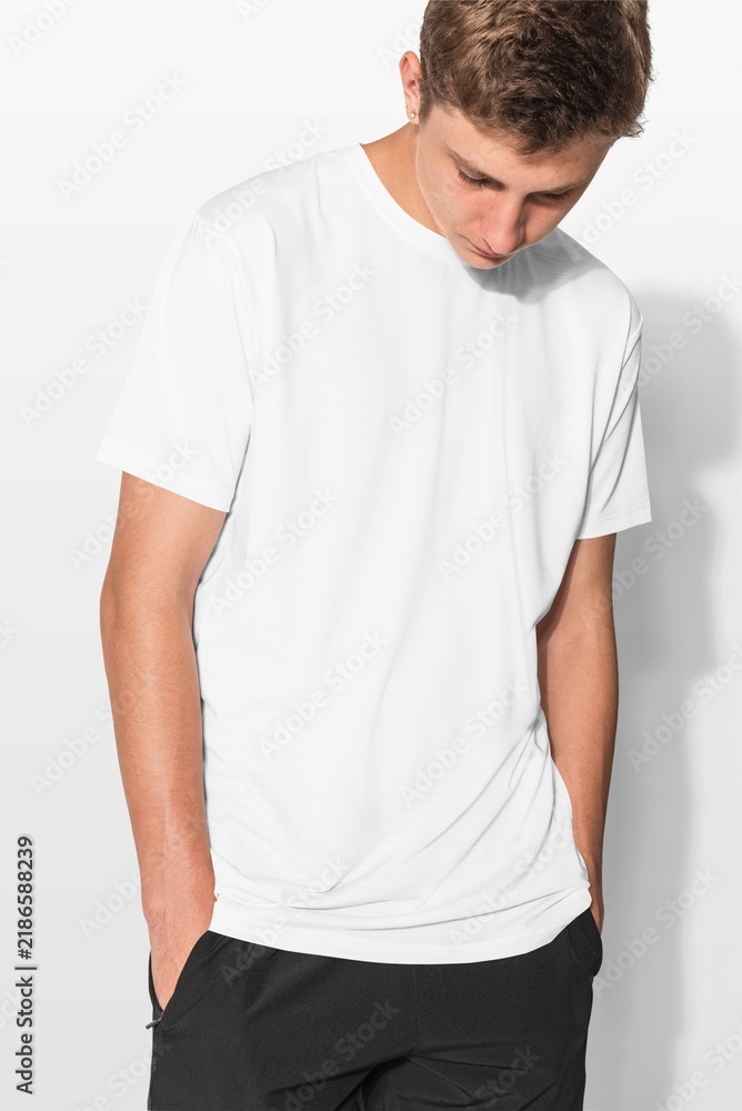 Obraz premium Young man in plain white t-shirt with hands in pockets