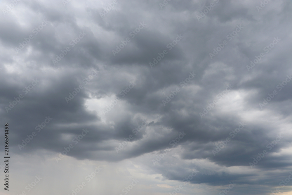 Fototapeta premium Dramatic storm clouds over a dark landscape