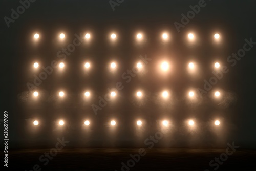Array of bright, warm lights illuminated against a dark, hazy background