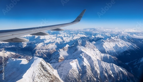 passenger plane above from snow mountains view from window mountain view from plane window