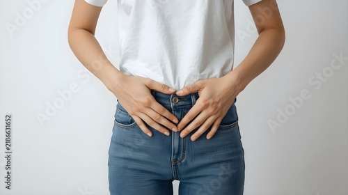 Woman holding her stomach with both hands expressing discomfort or pain