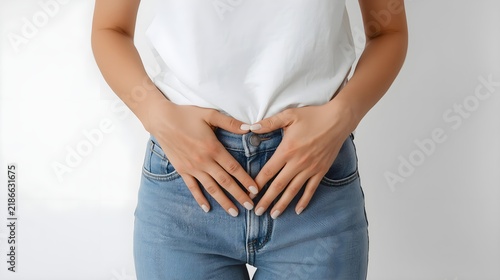 Woman holding her stomach with both hands expressing discomfort or pain