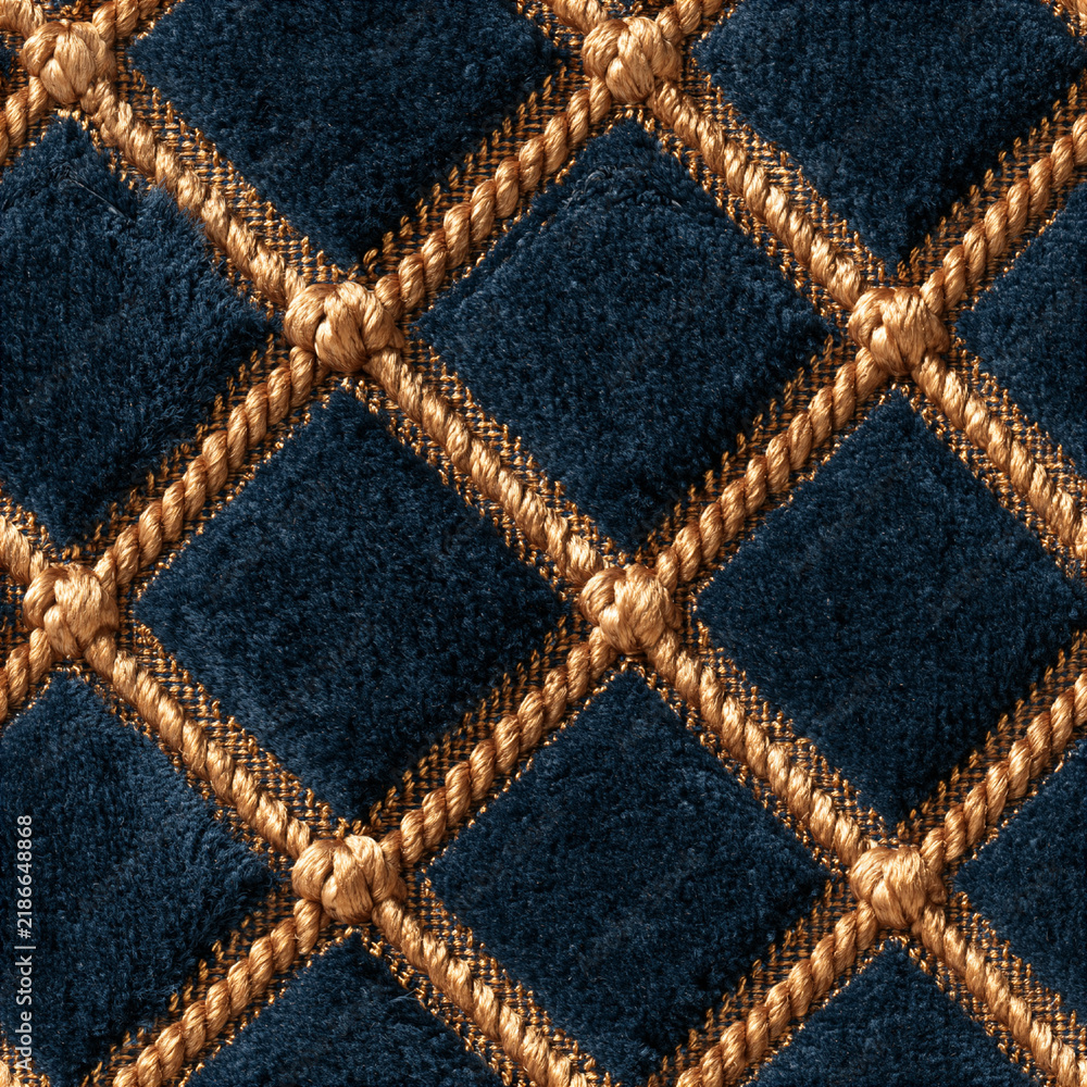 Naklejka premium Seamless pattern blue velvet fabric creating a luxurious quilted diamond pattern, accentuated by golden braided cords. Elegant and rich texture