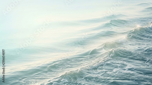 Dynamic ocean waves rolling in with gentle sea foam and soft natural sunlight illuminating the crests for a peaceful marine backdrop