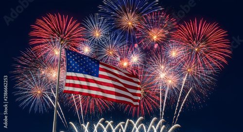 Bright colorful fireworks display behind the american flag for veterans day celebration