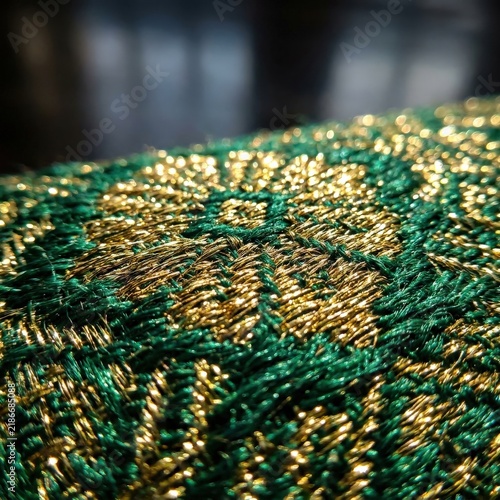 Luxury green and gold woven fabric with metallic threads in macro detail