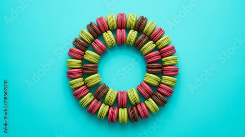 Matcha red velvet and chocolate macaroons circle in blue background