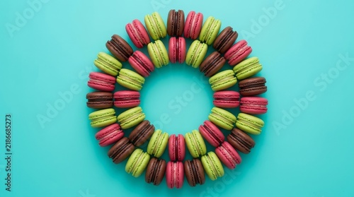 Matcha red velvet and chocolate macaroons circle in blue background