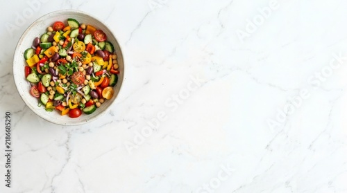 White salad bowl with various vegetables on white marble table for copy space healthy life campaign 