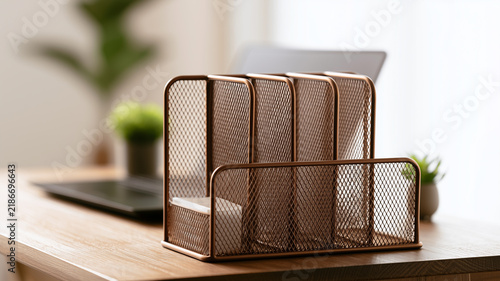 Professional office desk featuring a durable metal mesh file sorter with multiple upright compartments for document organization. Ai generat