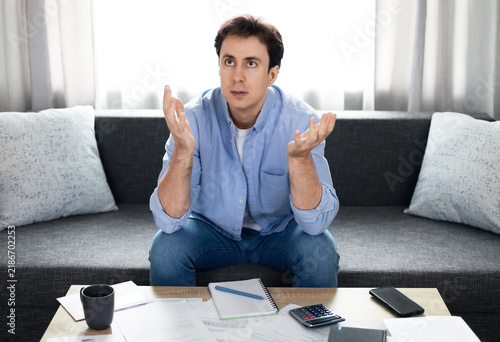 Bild auf Leinwand Stressed man reacts to unpaid utility bills and financial problems