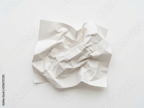 A single piece of white crumpled paper ball isolated on a plain background