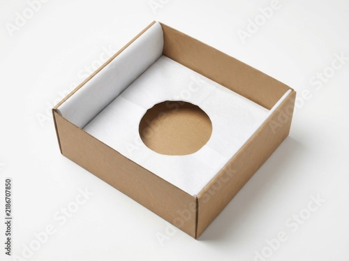 Open brown cardboard box with a round hole insert tray for product packaging
