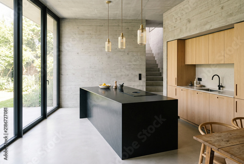Luxury Modern Minimalist Kitchen with Concrete Walls and Oak Island