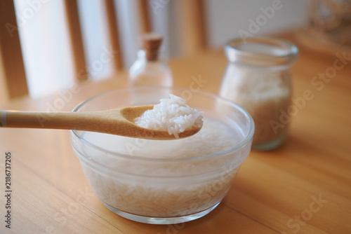 Принти на полотні rice water or a starchy rice extract being scooped with a wooden spoon from a gl