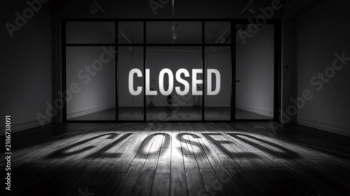 The silhouette of the word closed cast on a wooden floor within a vacant room