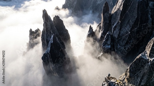 Person standing on obsidian spires