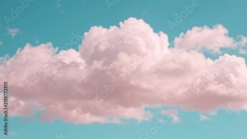 Soft pink clouds floating across a turquoise blue sky