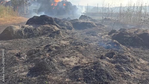 Fire in a village. Hay bales.