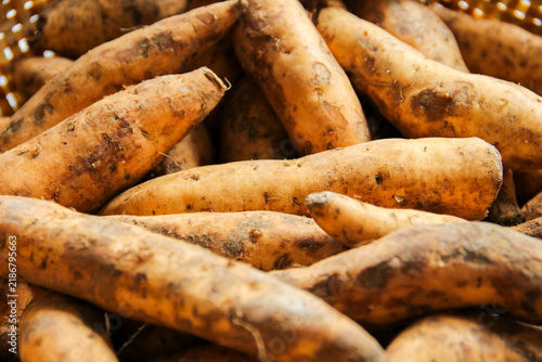 Photography Fresh sweet potatoes lie close, earthy tones dominate