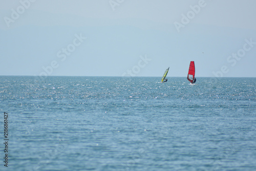 Windsurfing on the black sea. People on a boat on the sea. Athletes in water sports