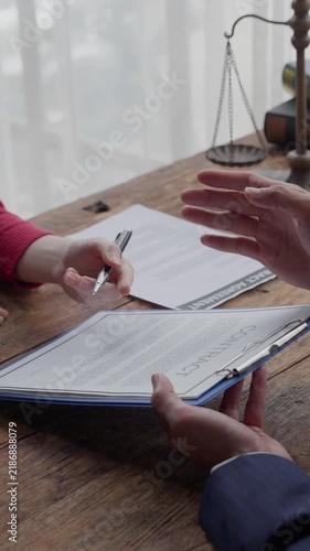 Businesswoman signing legal contract with a lawyer in the office