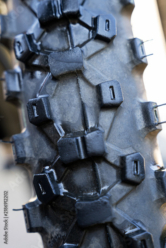Close-up of rugged motorbike tire tread and traction lugs